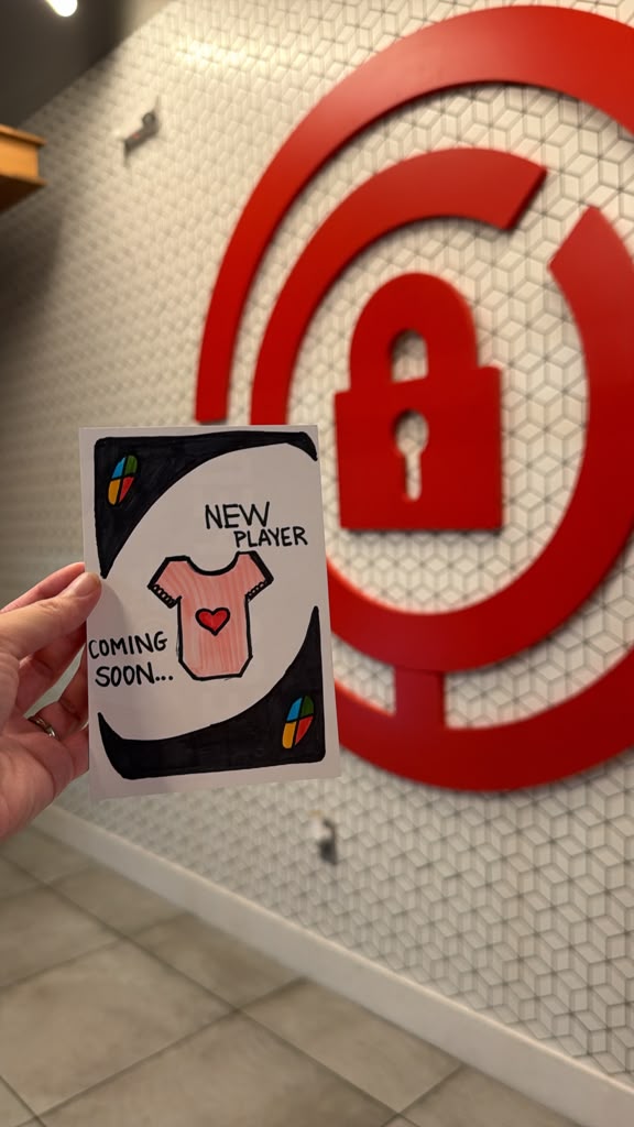 A hand-drawn Uno card reading New Player Coming Soon with a baby onesie